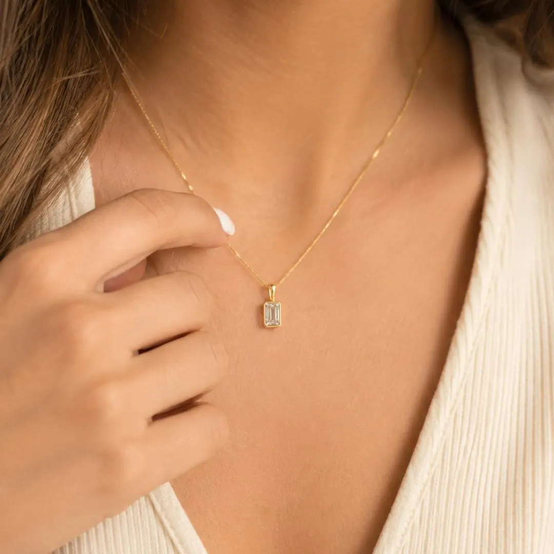 Emerald cut diamond pendant styling; chain not included