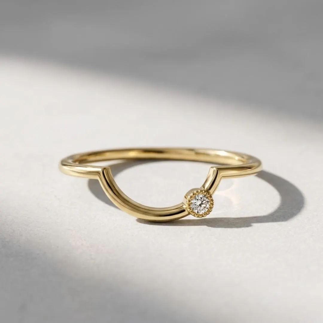AuvelleCo curved diamond contour wedding band in yellow solid gold with milgrain style bezel